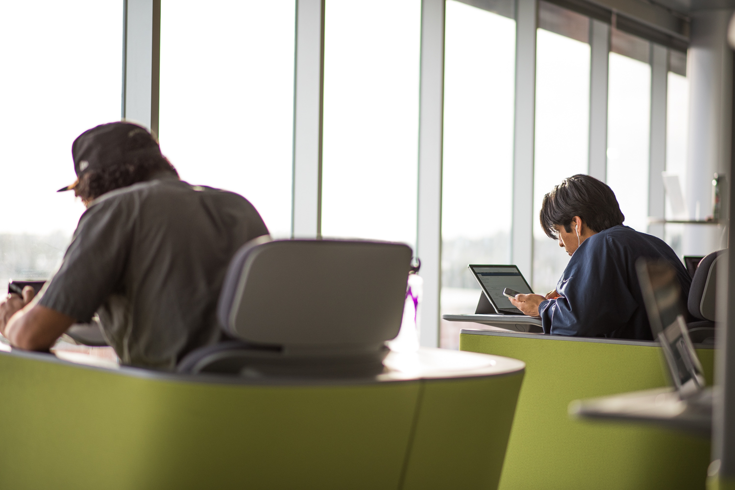 Students studying on campus with laptops