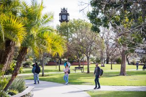 Students walking on campus near the clocktower