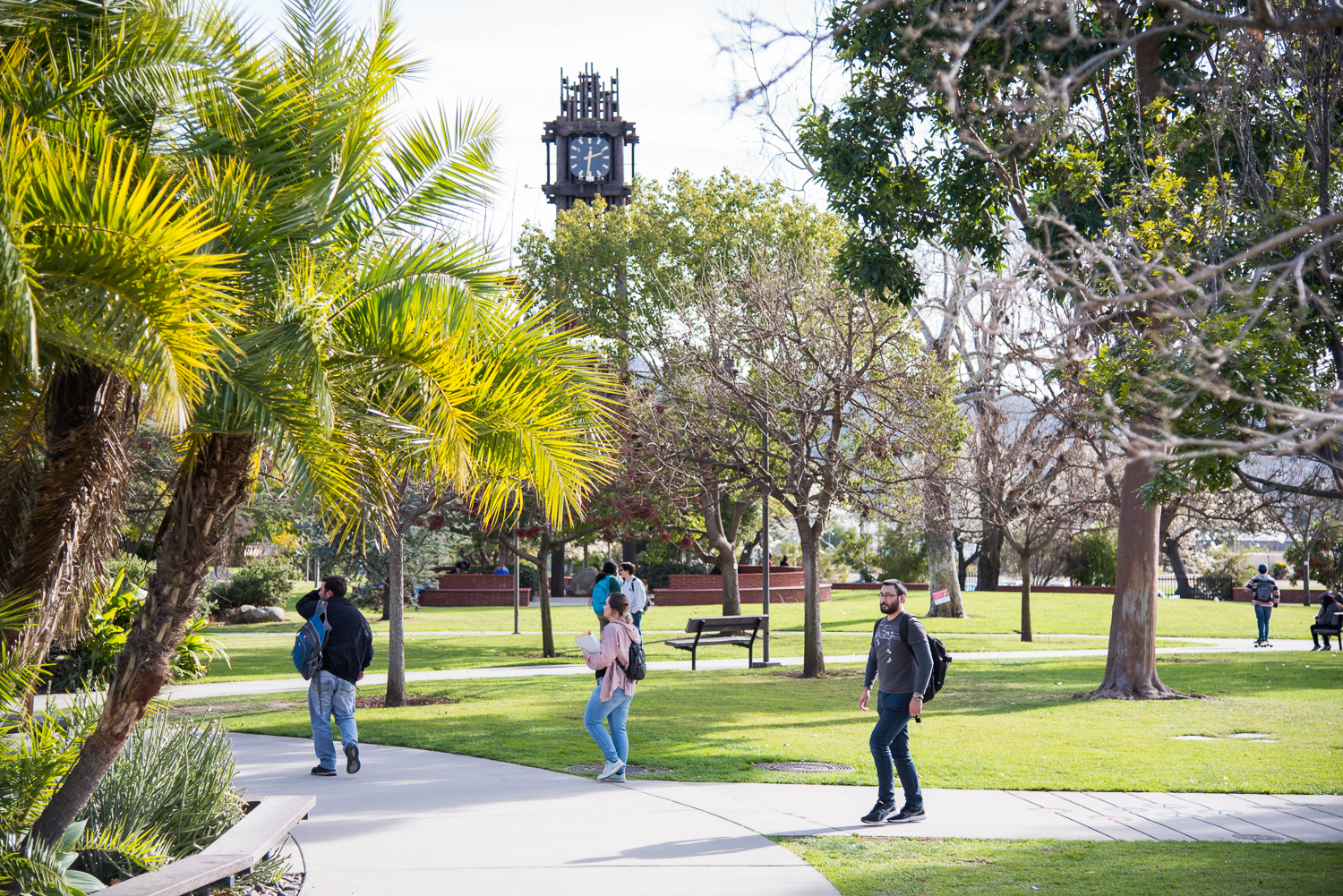 Students walking on campus near the clocktower