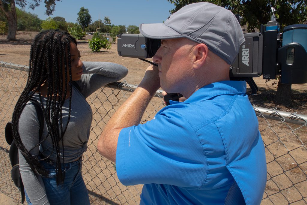 PCTV producer holding a camera and filming his documentary