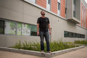 Palomar student Kory Nokes standing in front of a building on campus