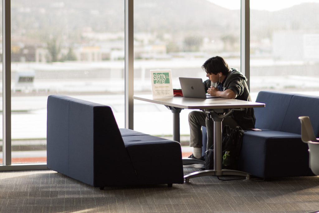 Student studying with laptop on campus
