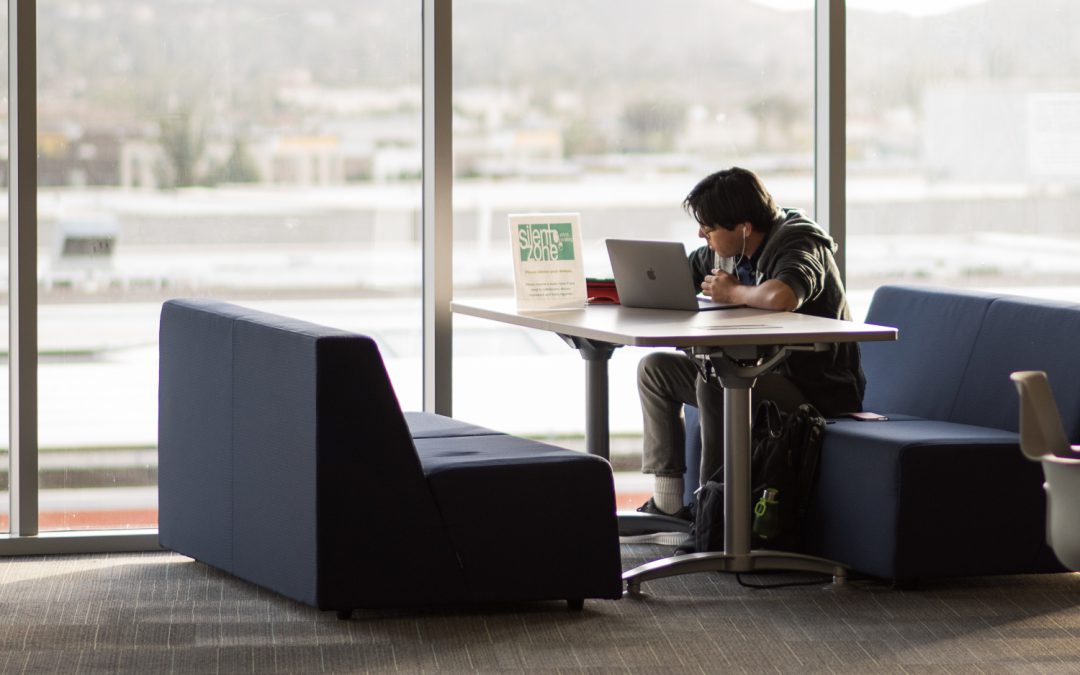 Student studying with laptop on campus