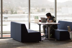 Student studying with laptop on campus