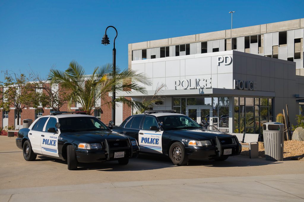 Two police cars in front of the police building on campus