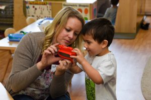 Child with teacher in a classroom at the Early Childhood Education Lab School on campus