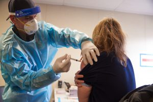 Barona Fire Department firefighter/paramedic, administering a COVID-19 vaccine