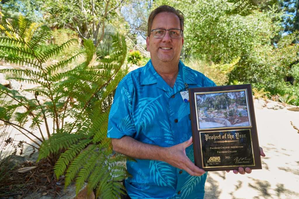 Dennis Astl holding the Palomar College Arboretum Award