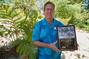 Dennis Astl holding the Palomar College Arboretum Award