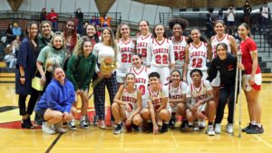Palomar College women's basketball team standing on the court