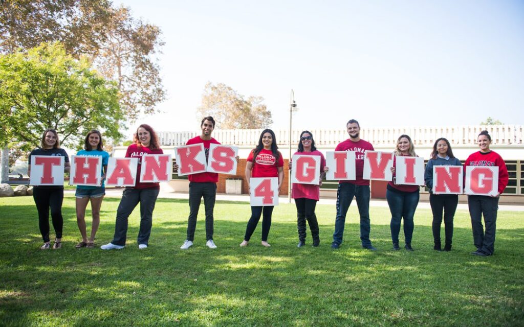 Palomar College Foundation holding letters that spell Thanks 4 Giving