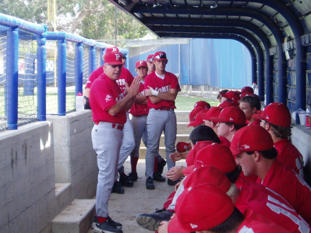 Palomar baseball team wearing uniforms in the dugout