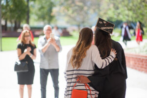 Family members taking pictures with graduates at Commencement