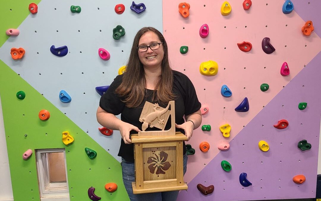 Student holding woodworking projects