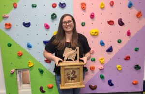 Student holding woodworking projects