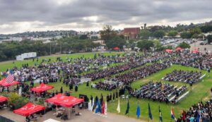 Students and attendees seated on the lawn at the Palomar College 2024 Commencement ceremony