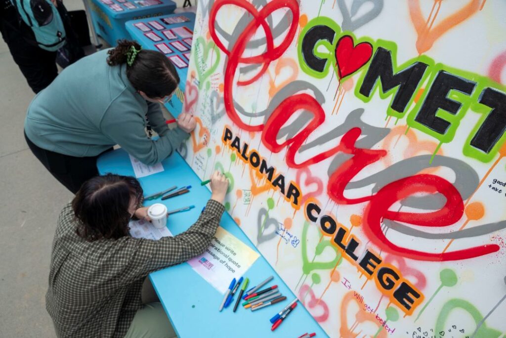 Photo of IMALIVE attendees adding to a mural