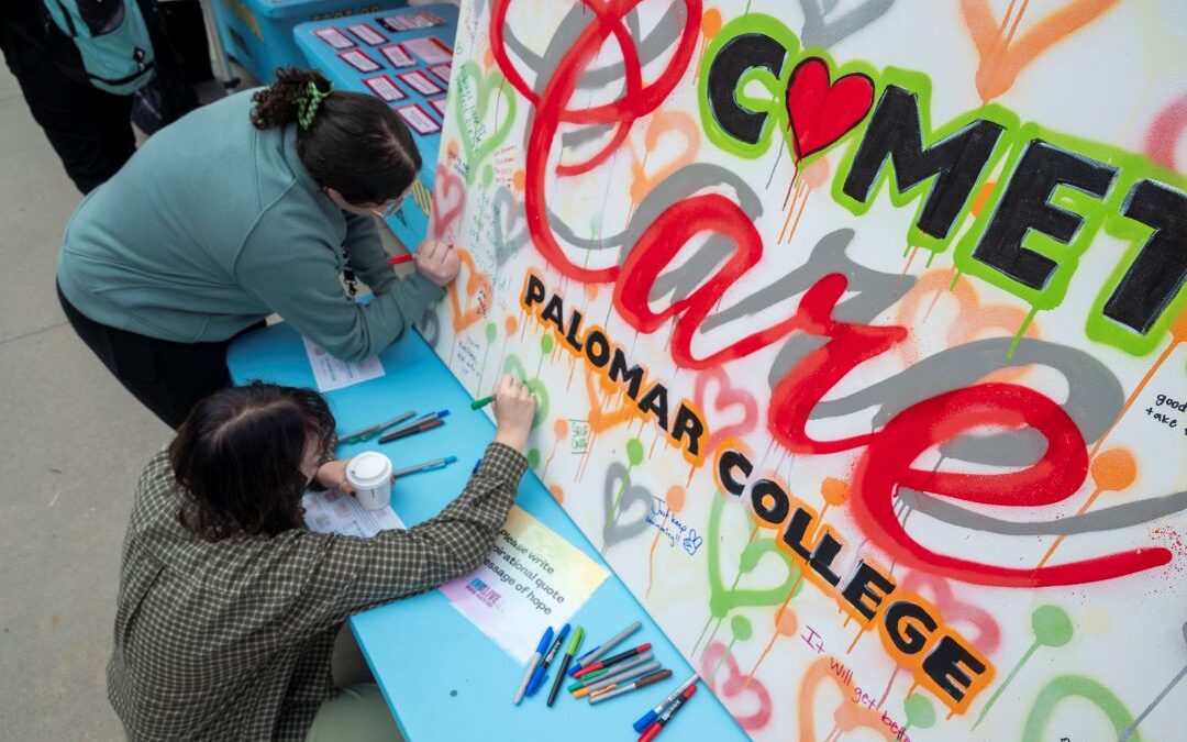 Photo of IMALIVE attendees adding to a mural