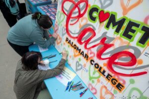 Photo of IMALIVE attendees adding to a mural