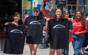 Palomar students holding up Palomar Promise shirts