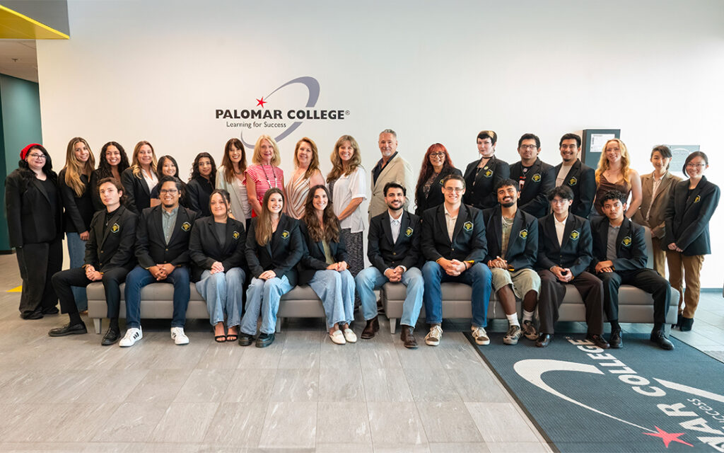 The 2026 first cohort of Palomar College bachelor’s degree students with college and faculty leaders and representative from Hunter Industries, a Palomar College Foundation donor standing in front of the Palomar College logo in the lobby of the Rancho Bernardo Education Center