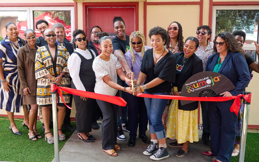 Palomar College employees cutting the grant opening ribbon for the Umoja Village at the San Marcos campus.