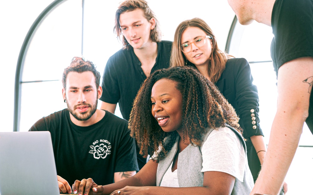 Group of people looking at a computer