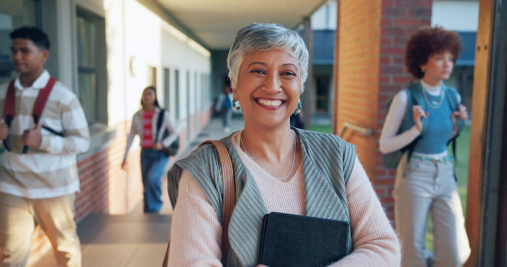 Mature woman, smiling with confidence in higher education setting.