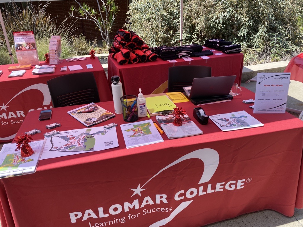 Info table with Palomar Swag on it