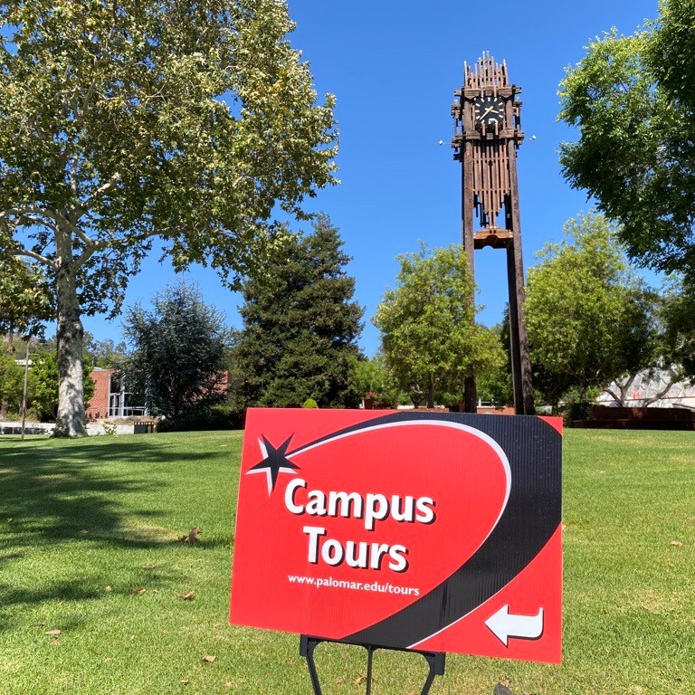 Campus tours sign in front of clock touwer