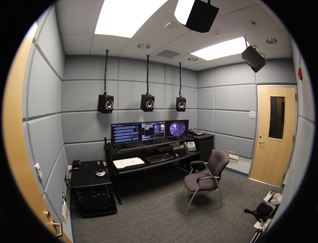The editing room is lined with sound modifying acoustic wall panels and has a 5.1 surround sound system. Adjacent to the editing room is a recording room lined with sound modifying acoustic wall panels. Production studio