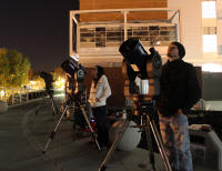 Student workers Ann and Steve learn how to use the telescopes for the planetarium. Looking into the night sky.