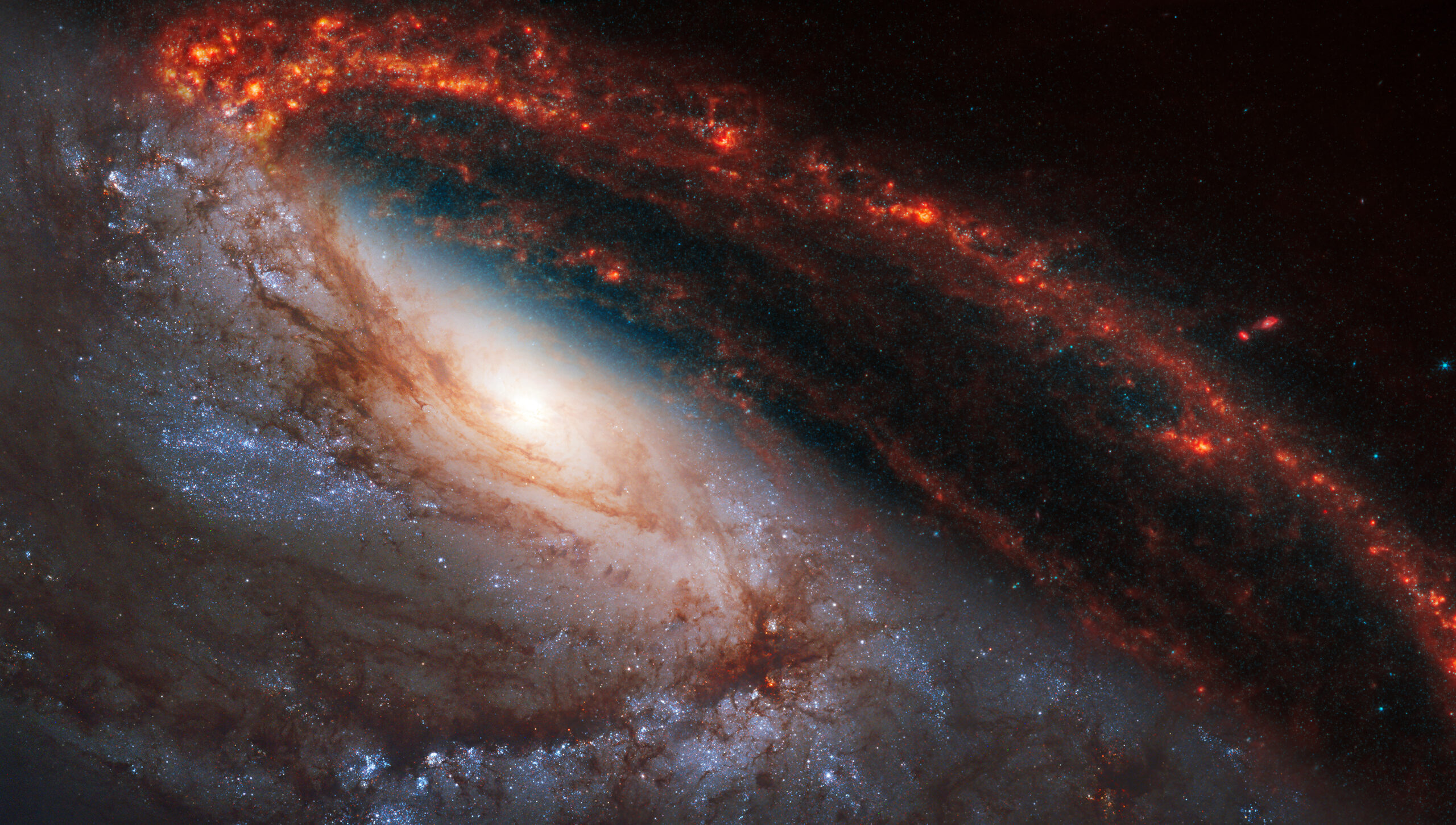 Panoramic spiral galaxy, NGC 3627. Bright orange, red, blue galactic long-range captured. Elements of this image furnished by NASA (combination of images observed by the Webb and Hubble telescopes)