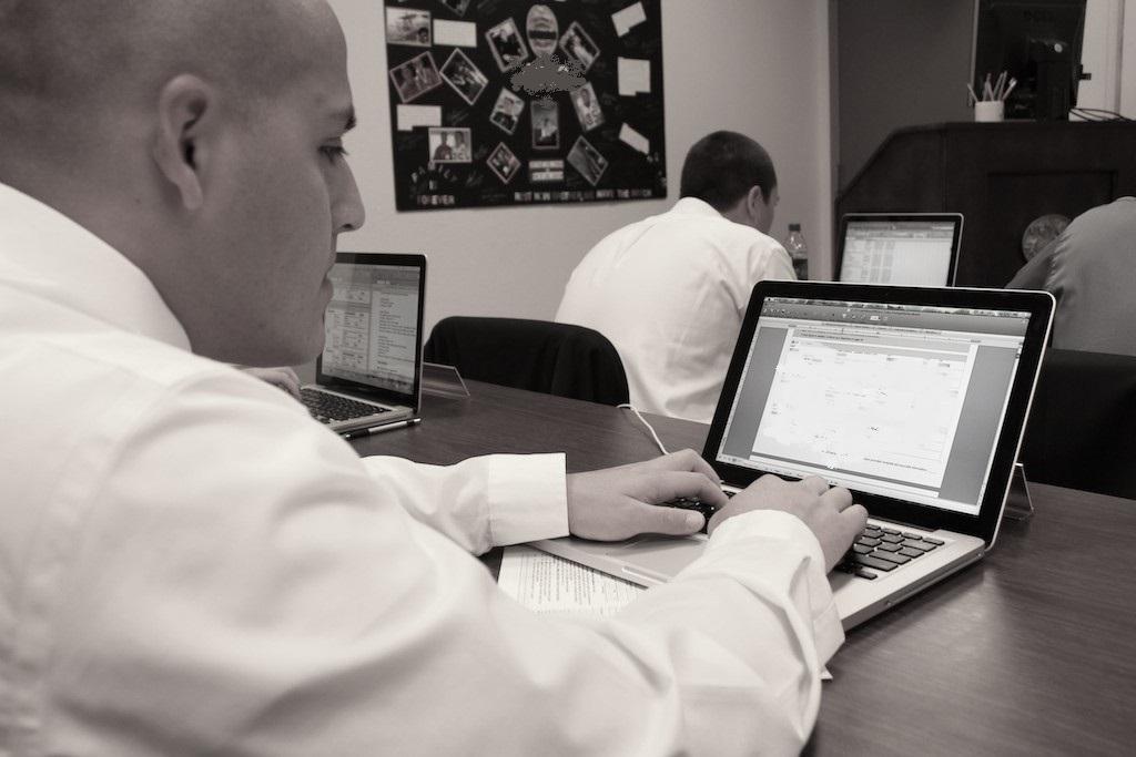 An academy student taking a test at a computer.