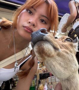 Sanja taking a photo with a deer.