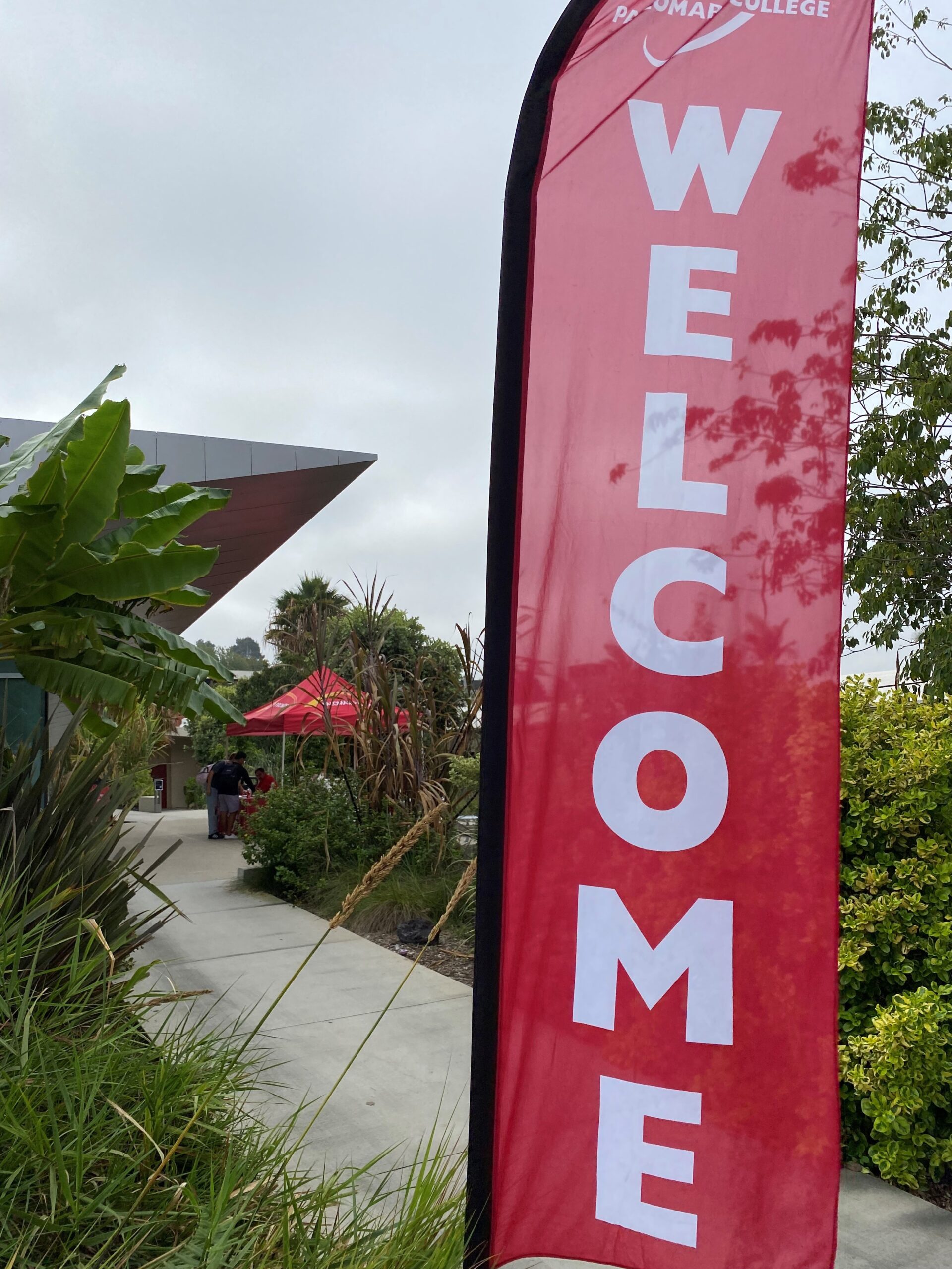 WELCOME Photo in front of trees on campus with welcome sign