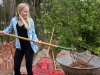 Madison Power, a STEM Ambassador, rakes mulch into a wheelbarrow at the Spring 2016 Arboretum Beautification Day on April 30. Michaela Sanderson/The Telescope