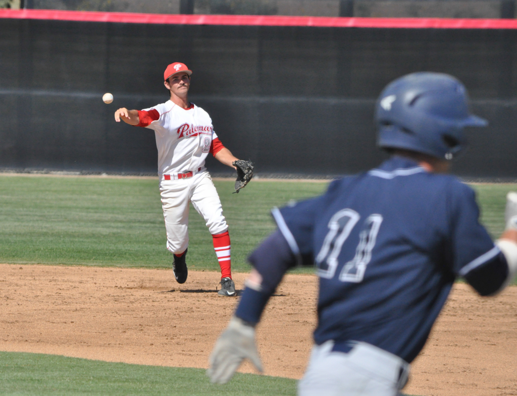 Palomar's second baseman Mitch Gallagher (20) fields a ground ball and throws the runner out at first base March 25 at the Palomar College Ballpark against San Diego Mesa. Palomar would go on to win 9-3. Aaron Fortin/ The Telescope