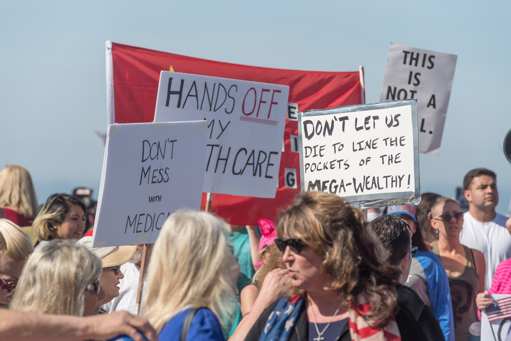 A large group of protesters gathered outside a town hall meeting hosted by Congressman Darrell Issa in Oceanside on March 11, 2017. Issa held two town hall meetings in a row, with the room filled with about 500 people, but there were still many more that were not able to attend. Joe Dusel / The Telescope