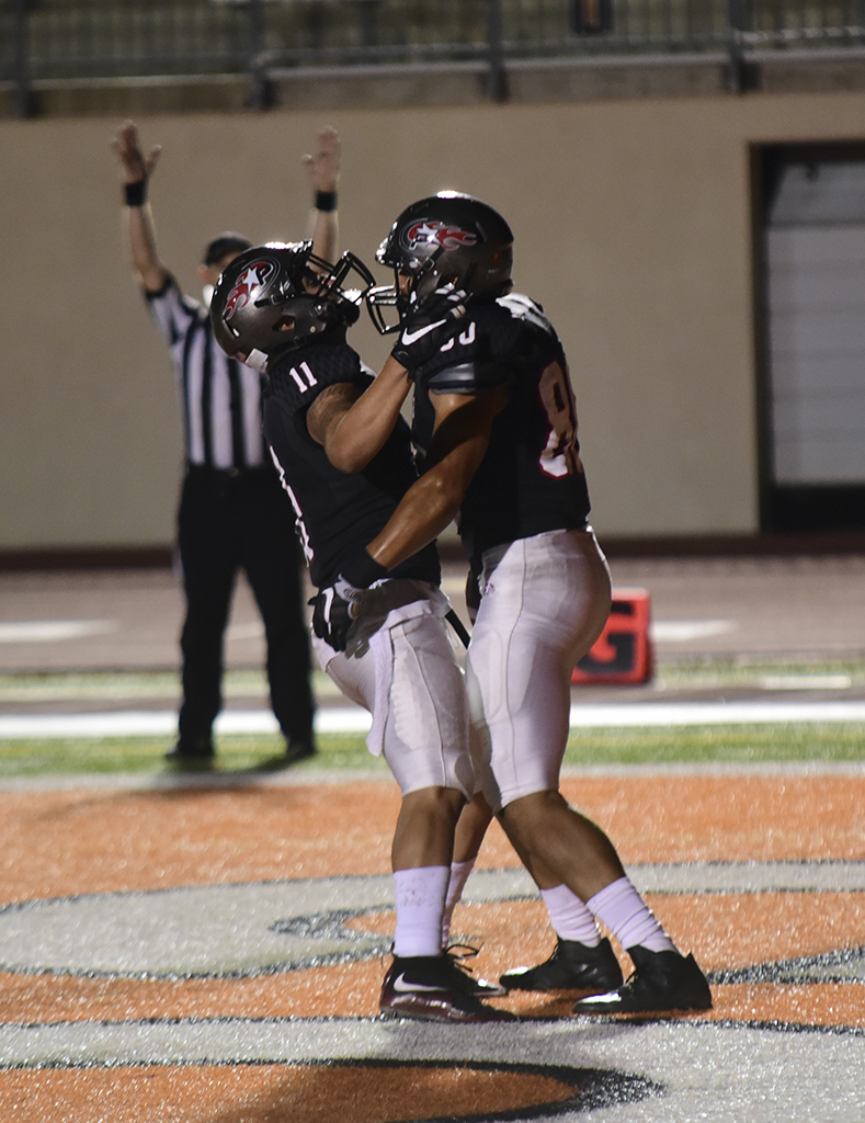 Palomar Robert Ursua (80) catches a touchdown pass from quarterback Matt Romero (2) to bring the Comets score 26 to 31 late in the fourth quarter against Moorpark Sept 24 at Escondido High School. Johnny Jones/The Telescope