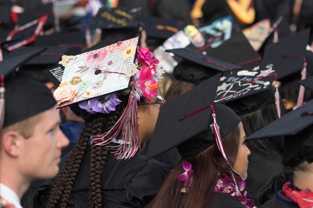 Happy graduating student with a graduating student with graduation cap customized with flowers at the Commencement Ceremony at Palomar College in San Marcos, Calif. on May 26, 2017. Joe Dusel / The Telescope