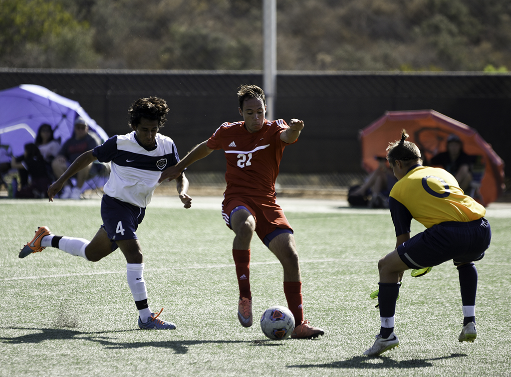 Palomar midfielder Mike Vidal (#21) dribbles past Cypress College defender Peter Carranza (#4) and attempts to shot around goalkeeper Braydon Welch (#0) at Minkoff Field. Palomar was defeated 2-1 on Sept. 6. Eric Szaras/The Telescope