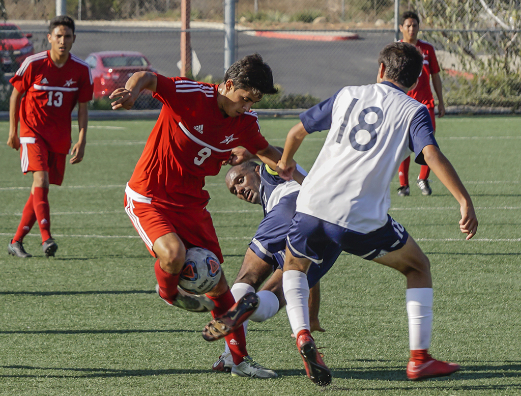 Palomar’s Argi Cerda (9) keeps control of the ball from to Cypress defenders Hawe Yonas (6) and Hugo Toledo (18) during the second half. The Comets hosted the Chargers at Minkoff Field Sept. 6 and lost 2-1. The Comets record now stands at (0-2-2 Overall, 0-0-0 PCAC). Philip Farry / The Telescope