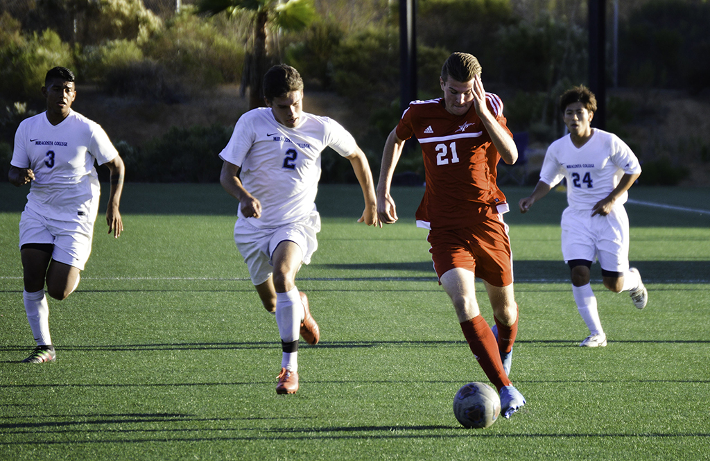 Palomar defender Tyler Burdick (21) dribbles past MiraCosta defender Emilio Bunnell Vasquez (2). Palomar was defeated 0-4 by MiraCosta Nov. 11 on Minkoff Field. The Comets finished the 2016 season (5-11-5). Dylan Halstead/The Telescope
