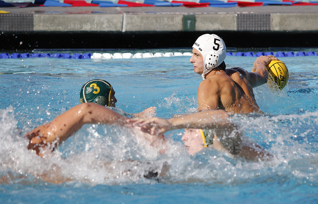 Palomar's Paul Schaner (5) gets ready to pass the ball over Grossmont's Nick Sedberry (3) during the Men's Water Polo game between Palomar and Grossmont on Oct. 26 at the Kroc Center. Coleen Burnham/The Telescope
