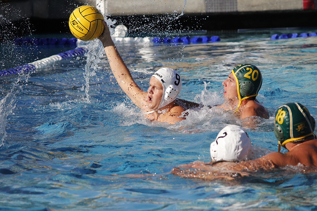 Palomar's Tim Sheehy (9) gains possession of the ball ahead of Grossmont's Naone Hasenstab (20) during the Men's Water Polo game between Palomar and Grossmont on Oct. 26 at the Kroc Center. Tristin D'Ambrosi (2) and Chase Lirley (18) look on. Coleen Burnham/The Telescope