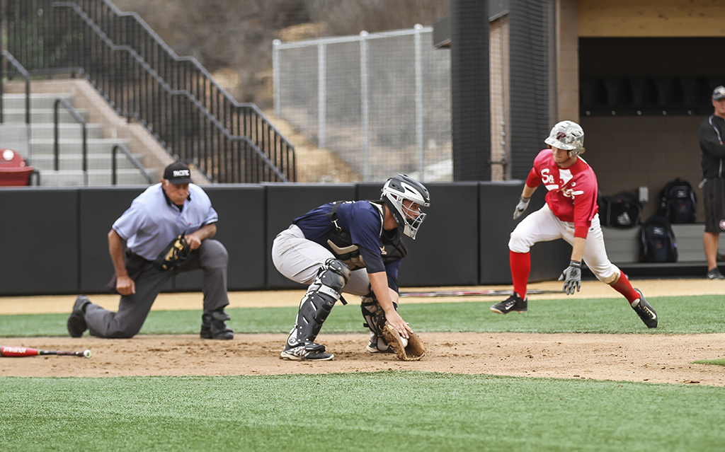 Palomar's Joey Cooper looks to avoid the tag of Orange Coast College catcher during the first inning of the scrimmage on Oct. 27. Cooper was called safe and scored the first run of the game. Philip Farry / The Telescope