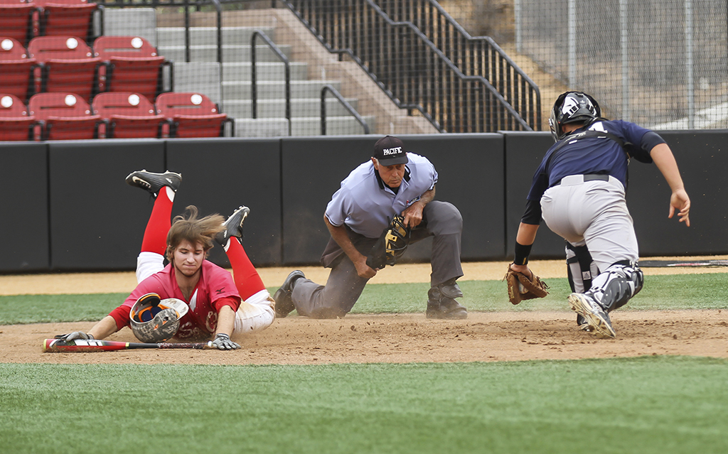 Palomar's Joey Cooper avoids the tag of Orange Coast College catcher during the first inning. of the scrimmage on Oct. 27 at the Palomar College ballpark. Cooper was called safe and scored the first run of the game. Philip Farry / The Telescope