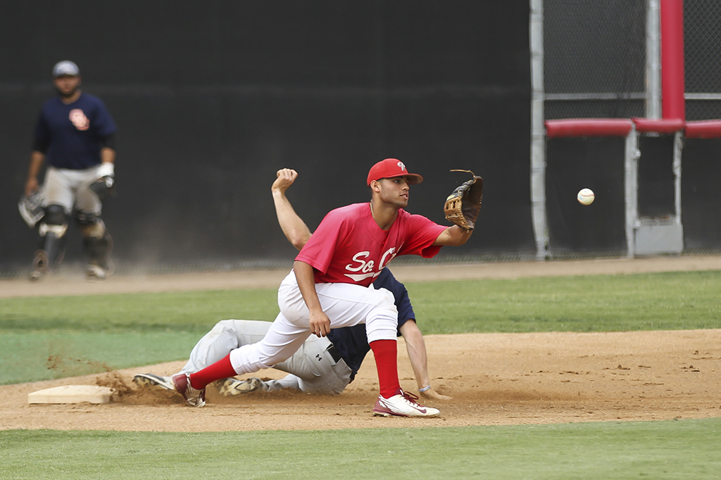 Palomar's Edgar Morales waits for the ball as an Orange Coast College player slides safely into third base during the third inning. in the scrimmage on Oct. 27 at the Palomar College ballpark. Philip Farry / The Telescope