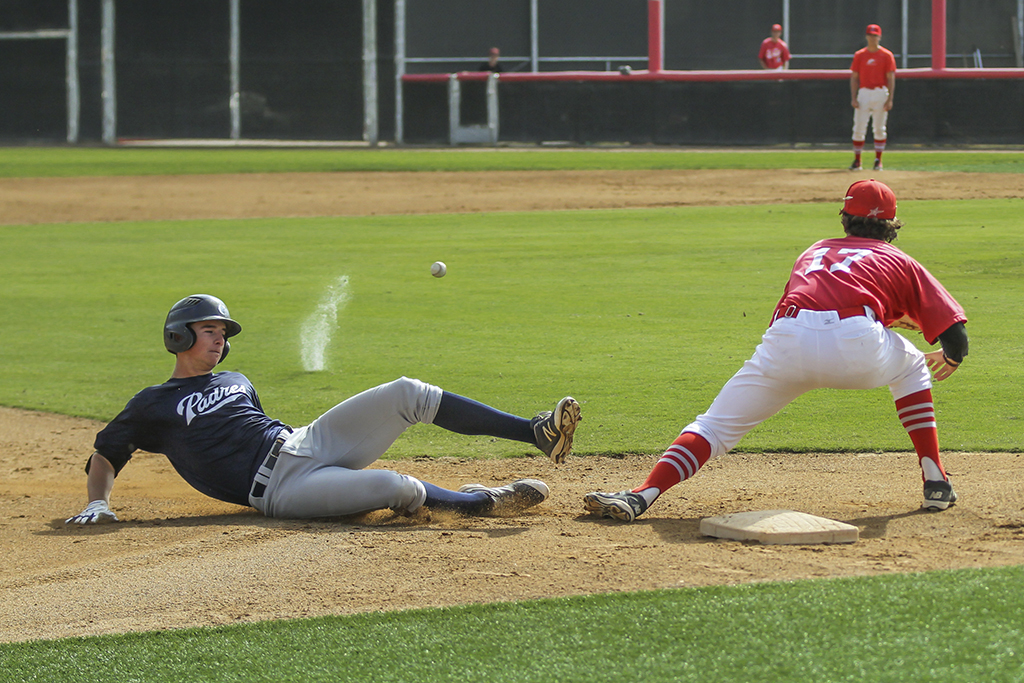 Palomar third baseman Connor McKenna waits for the ball as a San Diego Padre Scout team player slides into third base. The Comets hosted the Padres Scout team on Oct 29 at the ballpark on campus. Philip Farry / The Telescope